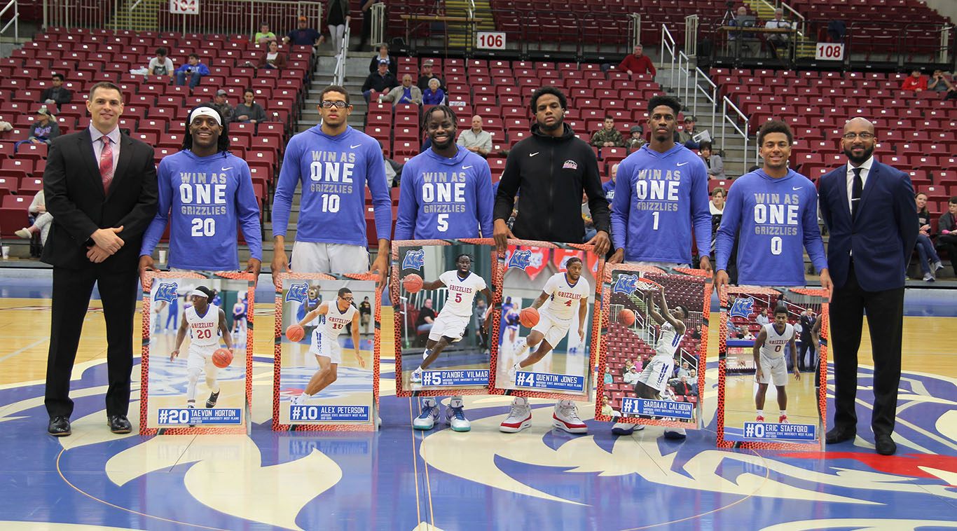 Grizzly team members and fans took a few moments before Wednesday’s home game to honor six sophomores for their contributions to the program. From left, Head Coach Chris Popp, Taevon Horton, Alex Peterson, D’Andre Vilmar, Quentin Jones, Sardaar Calhoun, Eric Stafford and Assistant Coach Aaron Proctor. (Missouri State-West Plains Photo)