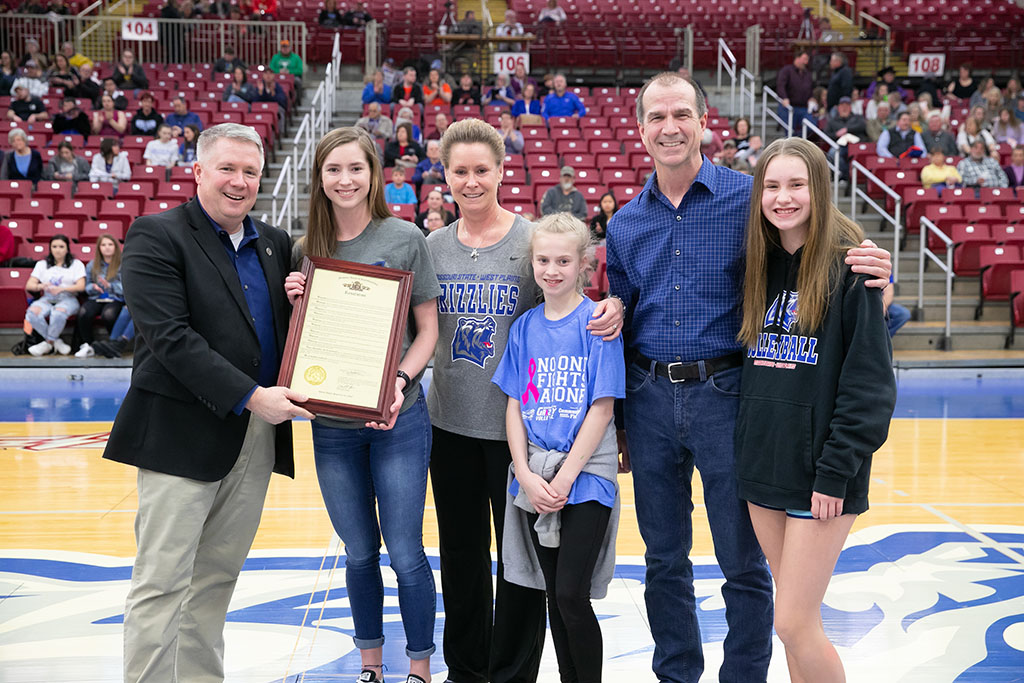 HONORED BY PROCLAMATION – 154th District State Rep. David Evans (R-West Plains), left, presents Grizzly Volleyball standout Kelly Wiedemann, second from left, a framed copy of the resolution approved by the Missouri House of Representatives honoring her for her athletic and academic achievements. With Evans and Wiedemann are her parents Paula and Warren Wiedemann and sisters, Emma and Lily, far right. (Missouri State-West Plains Photo)